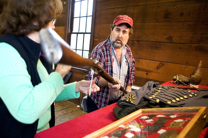 Jody Wright, right, and his mother, Mary Wright, unpack a Civil War-era firearm from Jody Wright’s collection. Pieces from his collection will be on display during the 10th annual Civil War Gun & Relic Show with Living History in Benton.