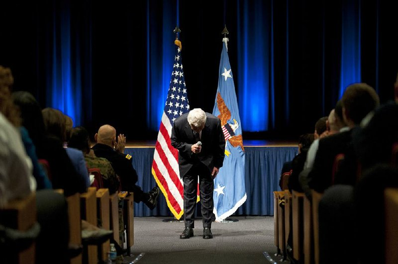 New Defense Secretary Chuck Hagel bows as he concludes his remarks to service members and civilian employees at the Pentagon, Wednesday, Feb. 27, 2013, after being sworn-in. Hagel took charge of the Defense Department Wednesday after a bruising confirmation fight _ and two days before billions in budget cuts are scheduled to hit the military. (AP Photo/Cliff Owen)