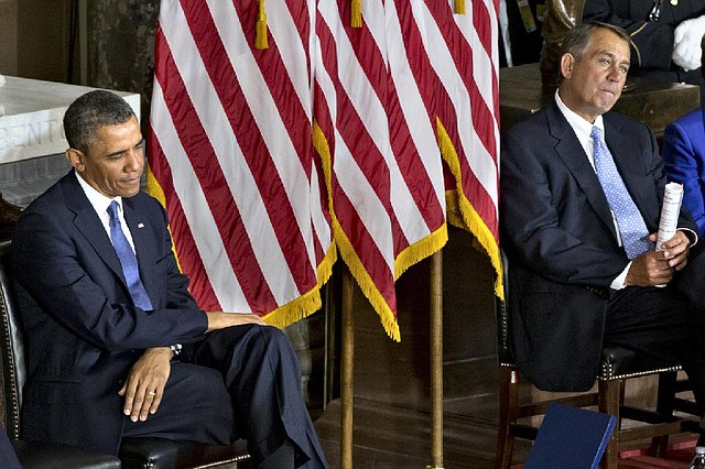 President Barack Obama, left, and House Speaker John Boehner of Ohio sit during a ceremony to dedicate a statue of civil rights icon Rosa Parks, Wednesday, Feb. 27, 2013, in the Capitol's Statuary Hall.  (AP Photo/J. Scott Applewhite)