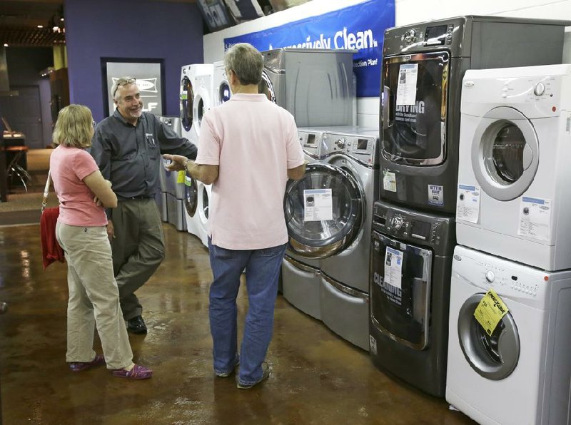In this Tuesday, Jan. 8, 2013 photo, a salesman shows customers washers and dryers at Aggressive Appliances store in Orlando, Fla. Orders for U.S. factory goods that signal business investment plans jumped in January by the most in more than a year, suggesting companies are confident about their business prospects. The Commerce Department said Wednesday, Feb. 27, 2013,  that orders for so-called core capital goods, which include industrial machinery, construction equipment and computers, rose 6.3 percent in January from December. A sharp fall in demand for commercial aircraft caused overall durable goods orders to drop 5.2 percent, the first decline since August. (AP Photo/John Raoux)
