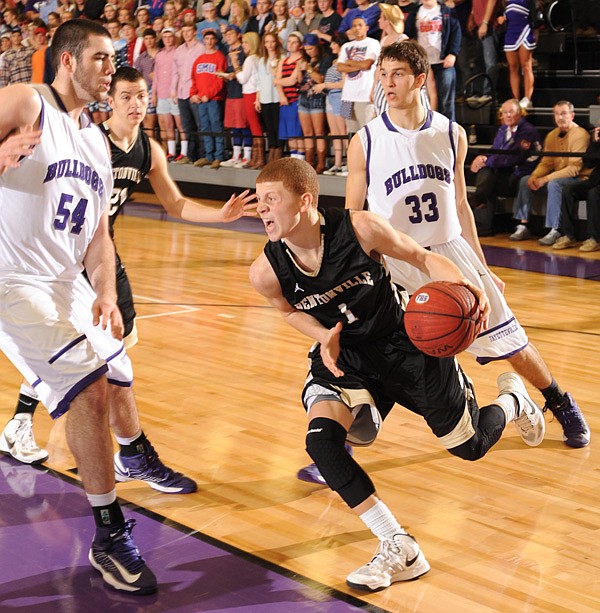 Tyler McCullough, left, Fayetteville senior post, and senior forward Caleb Waitsman apply pressure Jan. 25 on Bentonville freshman guard Tyrik Dixon at Fayetteville High. 