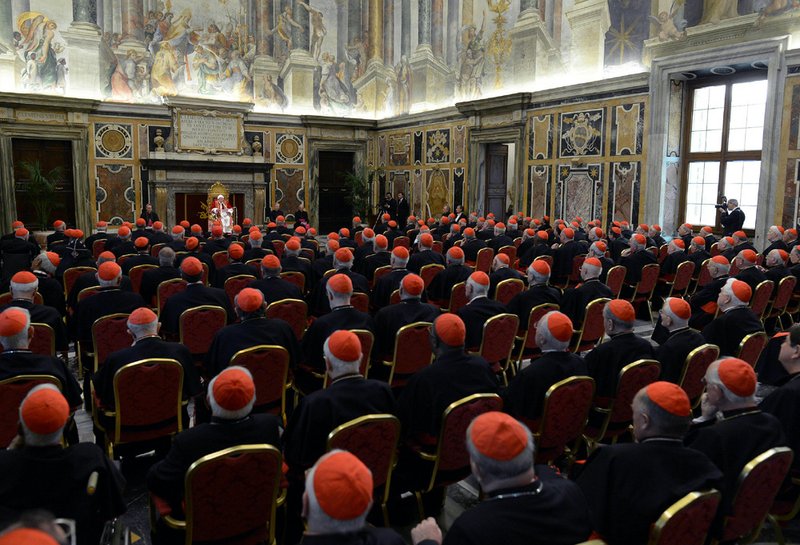 In this photo provided by the Vatican newspaper L'Osservatore Romano, Pope Benedict XVI, top center, delivers his message on the occasion of his farewell meeting to cardinals, at the Vatican on Thursday, Feb. 28, 2013. Benedict XVI promised his "unconditional reverence and obedience" to his successor in his final words to his cardinals Thursday, a poignant farewell before he becomes the first pope in 600 years to resign. 