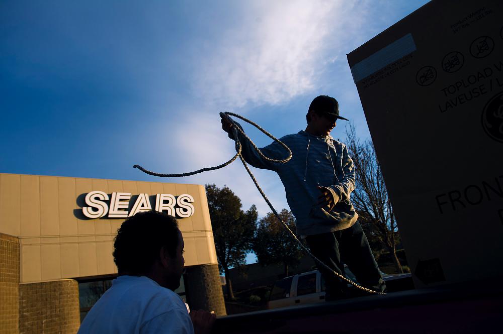 Customers secure a new washing machine purchased at a Sears Holdings Corp. store in the back of a pickup truck in Richmond, California, U.S., on Tuesday, Feb. 26, 2013. Sears Holdings Corp. is expected to release earnings data on Feb 28. Photographer: David Paul Morris/Bloomberg