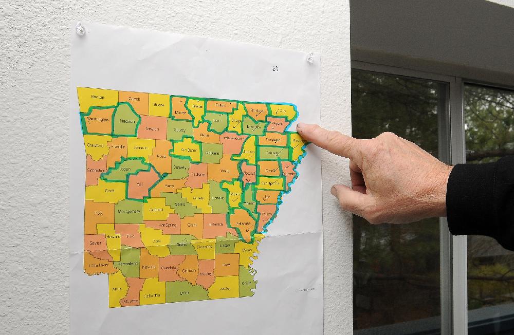 STAFF PHOTO SAMANTHA BAKER
George Dombek explains how he keeps track of the counties where a barn he plans to paint is located Wednesday, Feb. 27, 2013, at his studio in Goshen. Dombek plans to paint at least one image of a barn that is located in each of the 75 counties in Arkansas. Dombek's interest in barns began in the early 70s while working on his undergraduate degree in architecture at the University of Arkansas.