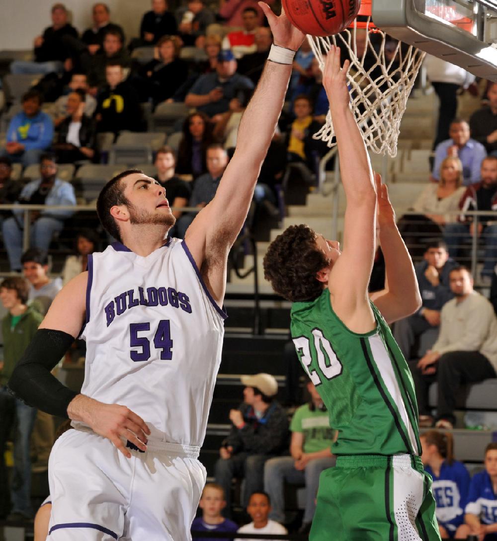 NWA Media/MICHAEL WOODS --02/22/2013-- Fayetteville High defender Tyler McCullough goes up to block the shot of Van Buren's Bradley Eversole as he drives to the hoop during the second half of Thursday evenings game in the boys 7A state basketball championships at Fayetteville High School.