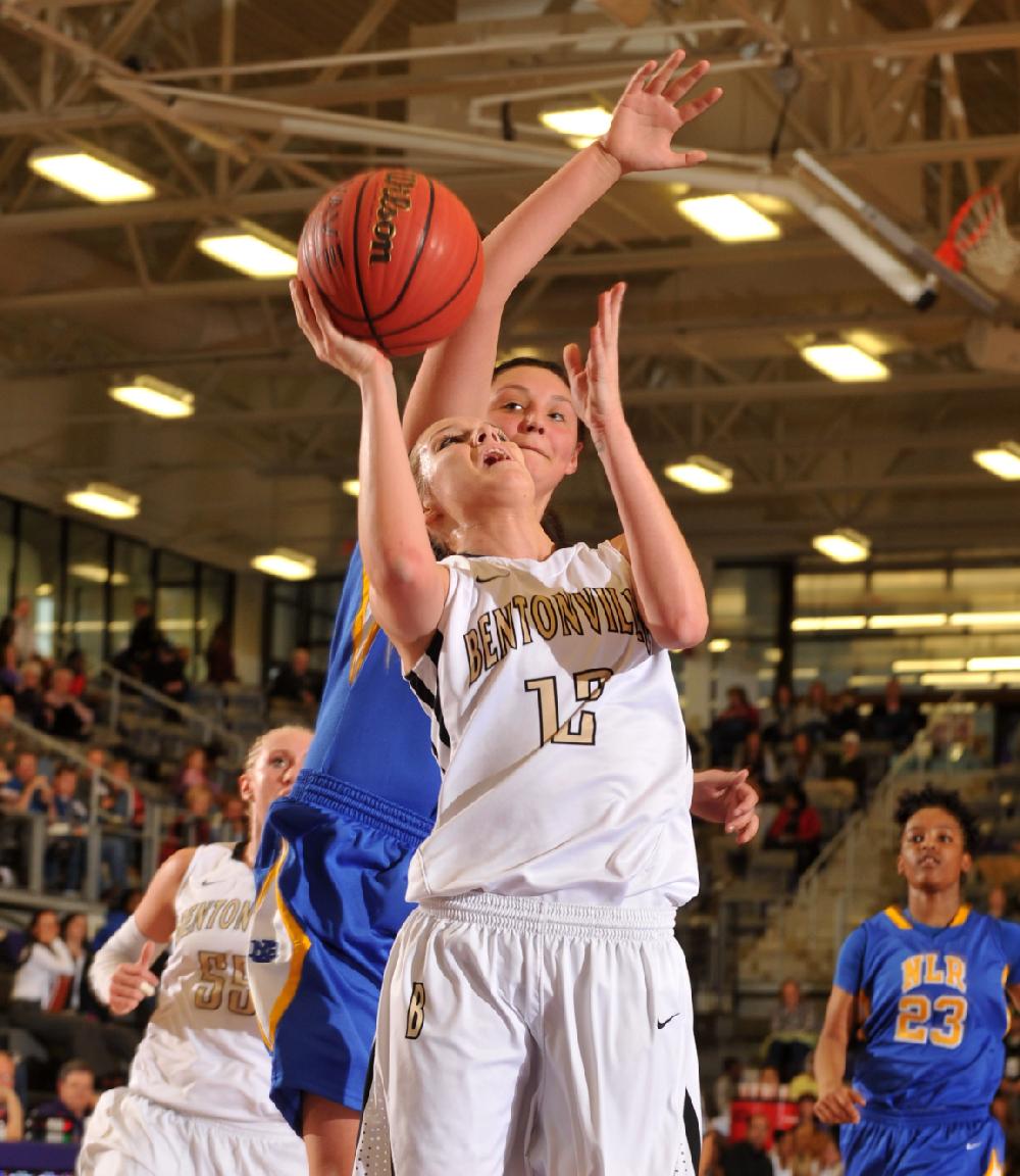 NWA Media/MICHAEL WOODS  --02/22/2013--  Bentonville's Taylor Lee tries to drive to the hop past North Little Rock defender Halley Hill during the first half of Thursday evenings game in the girls 7A state basketball tournament in Fayetteville.