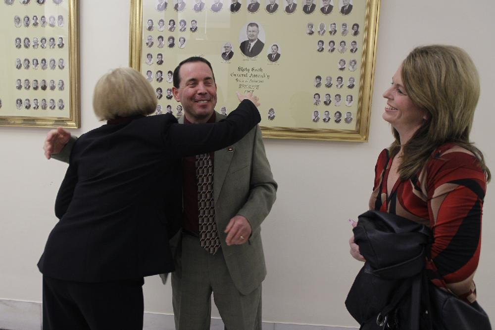 Rep. Andy Mayberry, R-Hensley, center, gets a hug from Rose Mimms, of Arkansas Right to life, left, as Mayberry's wife Julie watches outside of the Senate chamber at the Arkansas state Capitol in Little Rock, Ark., Thursday, Feb. 28, 2013. The Senate voted to override the governor's veto of Mayberry's bill banning most abortions in the 20th week Thursday. (AP Photo/Danny Johnston)
