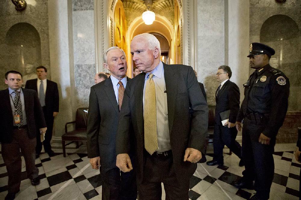 Sen. Jeff Sessions, R-Ala., center left, calls out to Sen. John McCain, R-Ariz., center, as they leave the Senate chamber during votes on last-ditch motions to block $85 billion in automatic spending cuts at the Capitol in Washington, Thursday, Feb. 28, 2013. (AP Photo/J. Scott Applewhite)