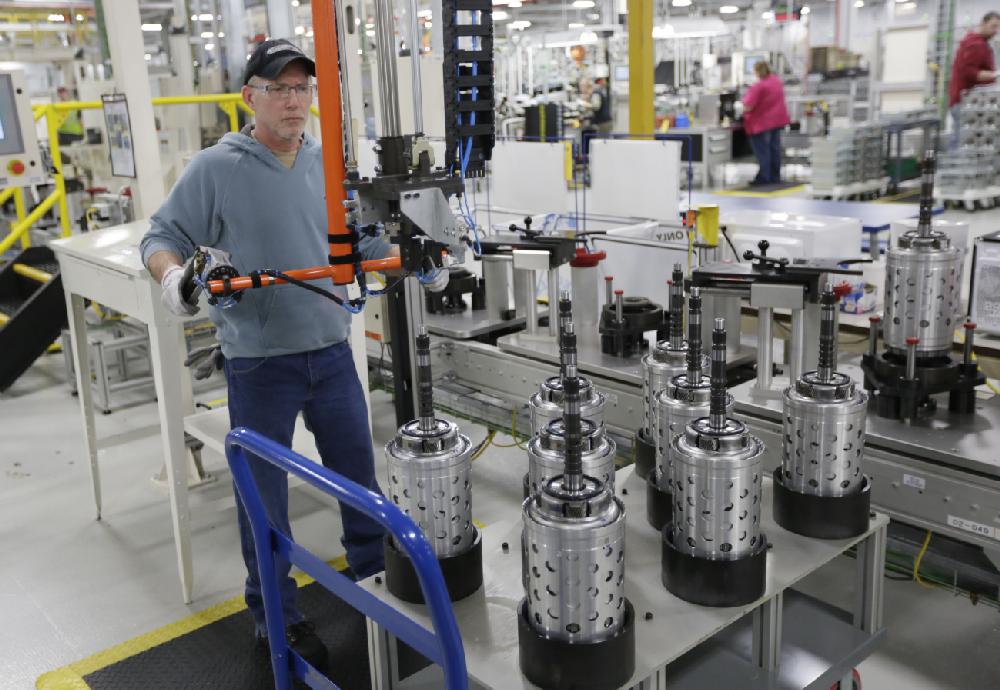 Dietz Werland works on the assembly line during a media tour before an investment and jobs announcement event at the Chrysler transmission plat in Kokomo, Ind., Thursday, Feb. 28, 2013. Chrysler will announce 1,250 new jobs and a major investment Thursday at transmission and metal casting factories in the Kokomo, Indiana, area. (AP Photo/AJ Mast)