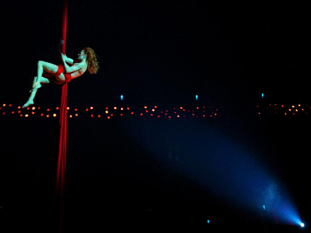 Arkansas Democrat-Gazette/BENJAMIN KRAIN --2/28/2013--
Aerial contortionist Julie Cameron hangs high over the stage as she cradles herself in a column of red fabric during a performance of Cirque Du Soleil Quidam at Verizon Arena on Thursday night. The show continues through Saturday.