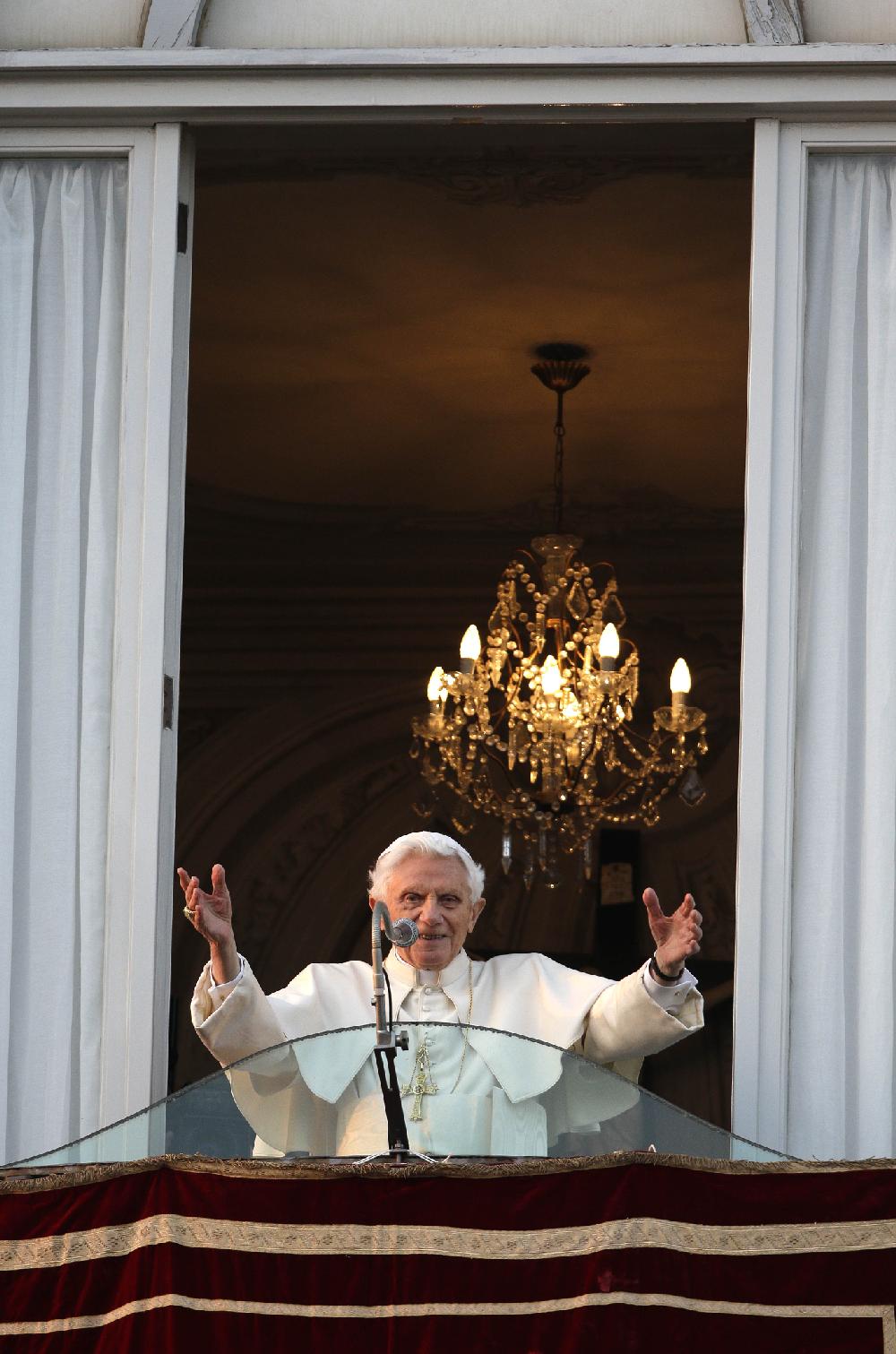 Pope Benedict XVI greets the crowd from the window of the Pope's summer residence of Castel Gandolfo, the scenic town where he will spend his first post-Vatican days and make his last public blessing as pope,Thursday, Feb. 28, 2013. (AP Photo/Andrew Medichini)
