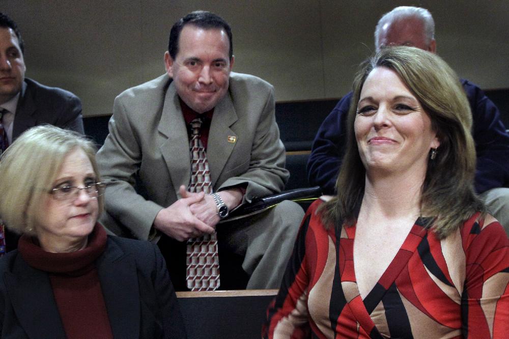 Julie Mayberry, right, wife of Rep. Andy Mayberry, R-Hensley, center, and Rose Mimms, executive director of Arkansas Right to Life, left, sit in a gallery at the Senate chamber at the Arkansas state Capitol in Little Rock, Ark., after the Senate voted to override the governor's veto of Mayberry's bill banning most abortions in the 20th week Thursday, Feb. 28, 2013. (AP Photo/Danny Johnston)
