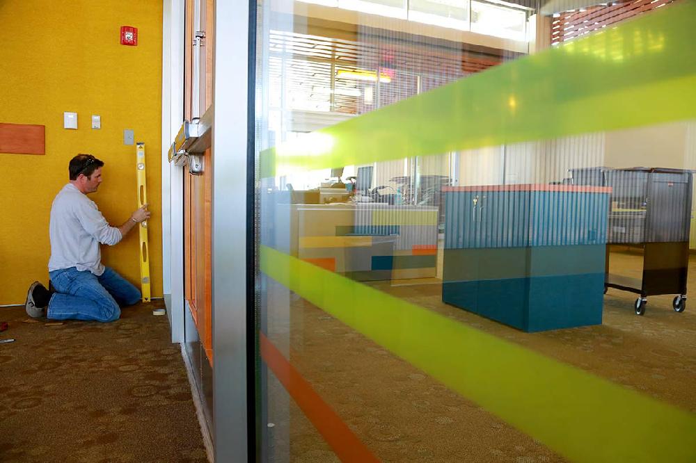 2/28/13
Arkansas Democrat-Gazette/STEPHEN B. THORNTON
Charles Aitkens, with DFI Architectural Signs, installs decorative striping Thursday afternoon on windows inside Central Arkansas Library System's Children's Library and Learning Center under construction at 4800 W. 10th St. in Little Rock. The 30,000 square foot library sets on a six-acre site south of I-630 south of the Little Rock Zoo. The Children's Library will open to the public opens on Saturday, March 16. (AITKENS IS CQ)