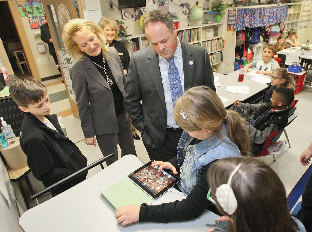 El Dorado News-Times/Michael OrrellSpecial guest: Hugh Goodwin Elementary student Elise Gasaway, second from right, demonstrates how the school uses IPads as an educational tool to Arkansas Lt. Governor Mark Darr as Eli Shepherd, left, principle Connie Reed and Maggie Toombs, right, look on. Shepherd, Gasaway and Toombs gave Darr a personal tour of the school during his visit. Darr was in El Dorado visiting area schools and officials on Thursday.