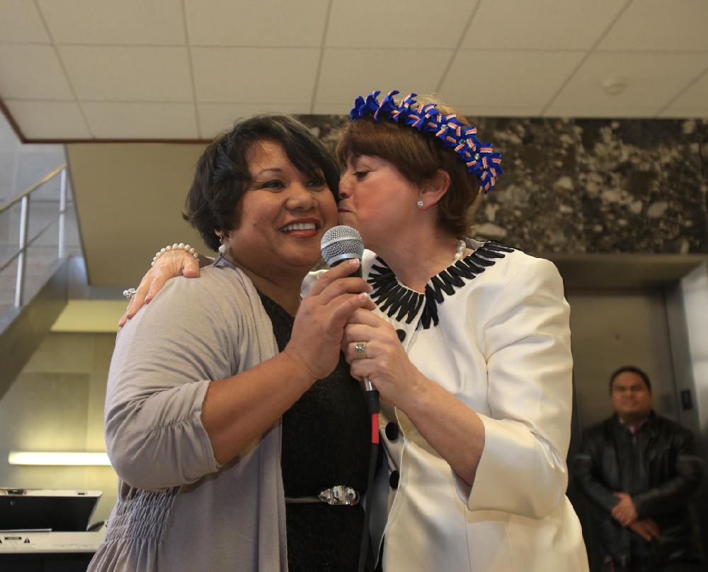 Arkansas Democrat-Gazette/STATON BREIDENTHAL --2/28/13-- Court interpreter services director Mara Simmons (right), gives Melisa Laelan a kiss Thursday morning after Laelan presented her with a wreath following a swearing in ceremony for new court interpreters. Laelan is the first person in the country to be sworn in as a certified Marshallese interpreter.