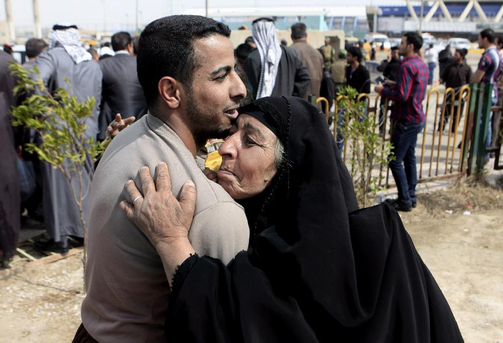 A former prisoner hugs his mother after being released from a prison in Baghdad, Iraq, Thursday, Feb. 28, 2013. Some 165 prisoners were released from the Iraqi Interior Ministry custody on Thursday. (AP Photo/ Karim Kadim)