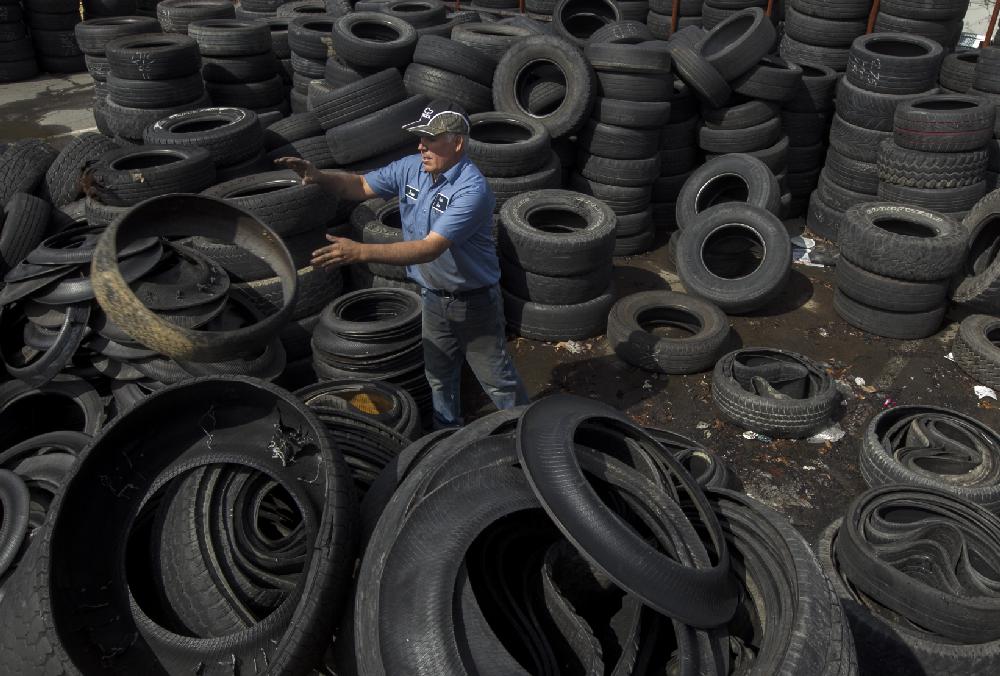 Arkansas Democrat-Gazette/BENJAMIN KRAIN --2/28/2013--
Jose Trujillo with Parker Tire & Auto on Harkrider St. in Conway, disassembles tire sidewalls from treads on scrap tires to reduce mosquito breeding and ensure they are propery recycled according to state law. The Arkansas Waste Tire Program law also requires dealers to pay $2 to the state per new tire sold to fund tire recycling and desposal operations.