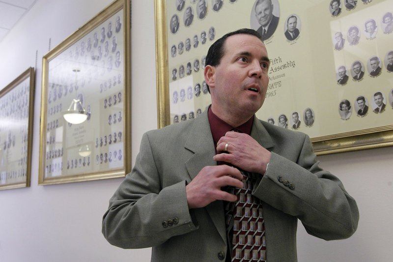 Rep. Andy Mayberry, R-Hensley, straightens his tie before speaking to reporters in a hallway outside the Senate chamber at the Arkansas state Capitol in Little Rock on Thursday, Feb. 28, 2013. The Senate voted Thursday to override Gov. Mike Beebe's veto of Mayberry's bill banning most abortions starting in the 20th week, a day after the state House voted to override it. 