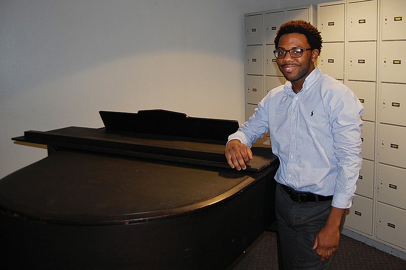 Marsalis Weatherspoon, a composer and graduate student at Henderson State University in Arkadelphia, looks over an old piano in the hallway of the Garrison Activity Center on campus. The 24-year-old musician is pursuing a master’s degree in liberal arts and hopes to one day teach on the college level.