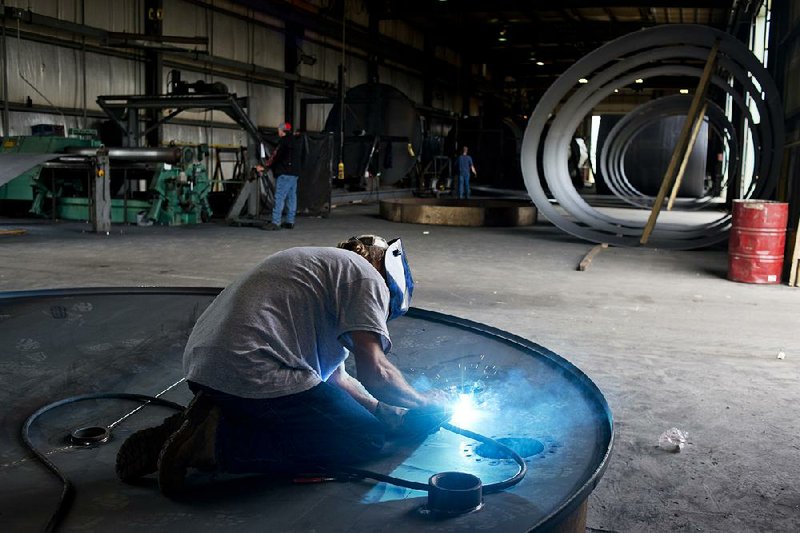 A welder works on oil tank tops  Westerman Companies Inc., a company that manufactures oil tanks for the fracking industry in Bremen, Ohio, U.S. on Tuesday, Sept. 4, 2012. A boom in oil production from the shale formations of North Dakota and Texas has the U.S. on a course to cut its reliance on imported crude oil to about 42 percent this year, the lowest level in two decades. Photographer: Ty Wright/Bloomberg