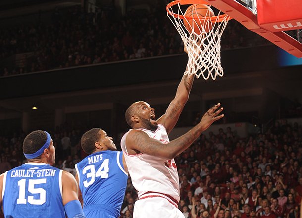 Arkansas junior forward Marshawn Powell dunks the ball past Kentucky guard Julius Mays (34) during the first half of play Saturday, March 2, 2013, in Bud Walton Arena in Fayetteville.