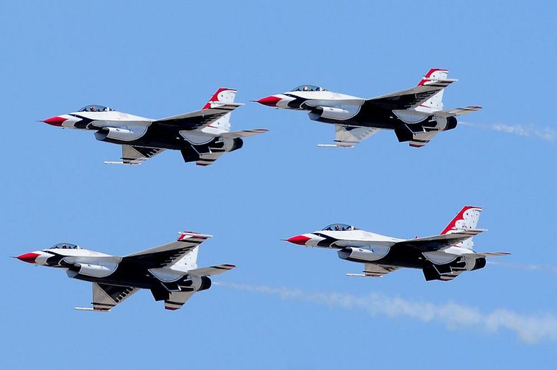 FLE - In this March 15, 2012 file photo, four members of the U.S. Air Force Thunderbirds demonstration team make a pass over the runway in formation before landing in Yuma, Ariz. The Air Force is saying it will ground the Thunderbirds without a federal budget deal, putting the popular flight event's appearance at this summer's Dayton Air Show in jeopardy. (AP Photo/The Yuma Sun, Craig Fry, File)