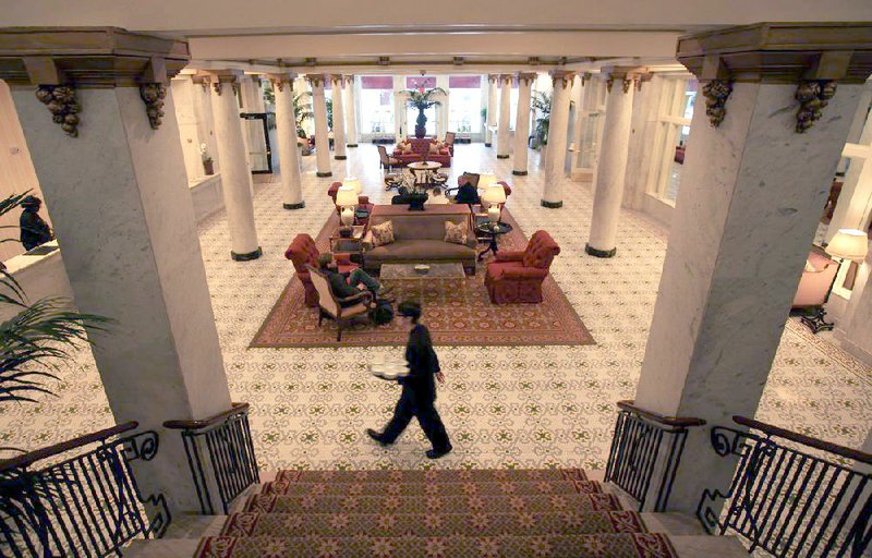 A Capital Hotel employee walks through the ornate lobby area of the downtown Little Rock Hotel Tuesday afternoon. The hotel has been awarded a Forbes Travel Guide four-star rating. 