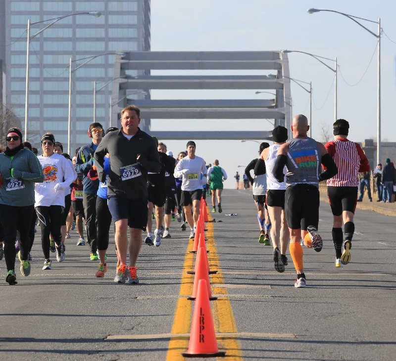 Runners cross the Broadway Bridge in both directions Sunday morning during the Little Rock Marathon. More photos are available at arkansasonline.com/galleries. 