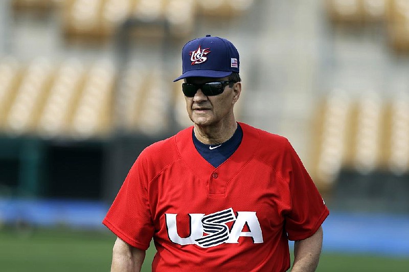 United States manager Joe Torre watches his players stretch before an exhibition baseball game Tuesday, March 5, 2013, in Glendale, Ariz. The game is the first of two exhibitions the team will play leading up the the start of the World Baseball Classic. (AP Photo/Mark Duncan)
