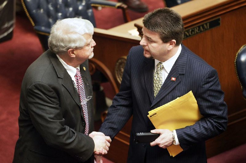 Sen. Jason Rapert, R-Conway, right, greets Sen. Bobby J. Pierce, D-Sheridan, on the floor of  the senate chamber at the Arkansas state Capitol in Little Rock, Ark., Tuesday, March 5, 2013. Pierce voted against an override of Gov. Mike Beebe's veto of Rapert's legislation that would ban most abortions from the 12th week of pregnancy onward. (AP Photo/Danny Johnston)