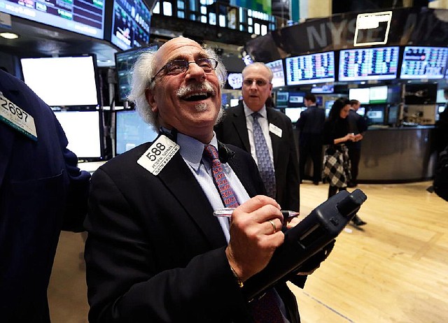 Trader Peter Tuchman smiles as he works on the floor of the New York Stock Exchange Tuesday, March 5, 2013. Five and a half years after the start of a frightening drop that erased $11 trillion from stock portfolios and made investors despair of ever getting their money back, the Dow Jones industrial average has regained all the losses suffered during the Great Recession and reached a new high. (AP Photo/Richard Drew)
