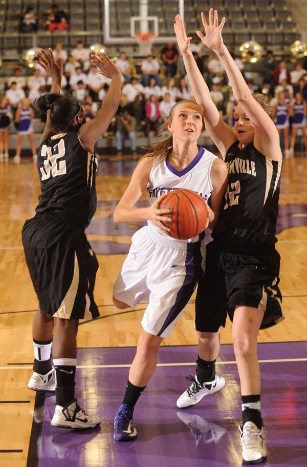 Fayetteville’s Ellie Breden, center, drives through the lane as Bentonville’s Taylor Lee, right, and Jamayne Potts, left, defend on Jan. 25 at Fayetteville High. Breden was among several sophomores who stepped in for the Lady Bulldogs after upperclassmen went down with injuries.