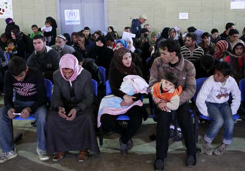 Syrian families wait their turn to register at the UNHCR center in the northern city of Tripoli, Lebanon, Wednesday, March. 6, 2013.  The number of Syrians who have fled their war-ravaged country and are seeking assistance has now topped the one million mark, the United Nations refugee agency said Wednesday warning that Syria is heading towards a "full-scale disaster." (AP Photo/Bilal Hussein)