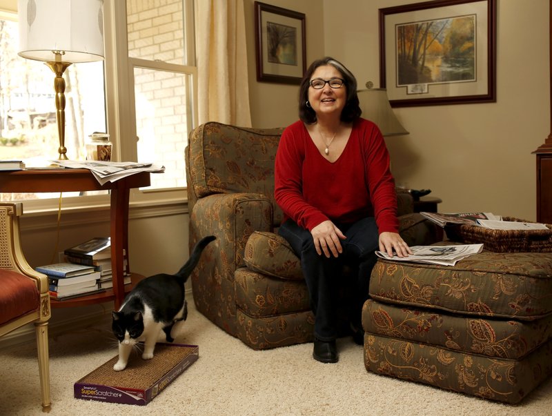 Kathy Spigarelli, director of the Adult and Community Education Center at the Fayetteville Schools, in her favorite personal space, the chair and ottoman area in the living room of her Fayetteville home.
