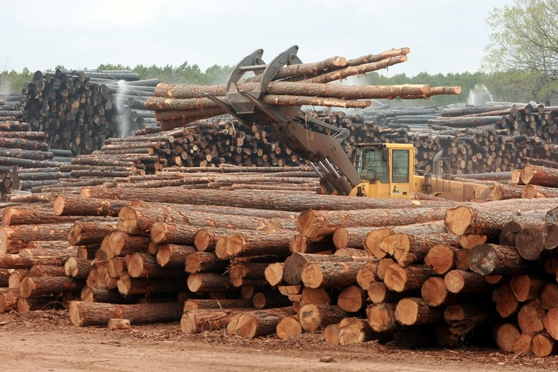 A large loader moves pine logs around at the Anthony Timberlands sawmill in Bearden in this 2011 file photo.