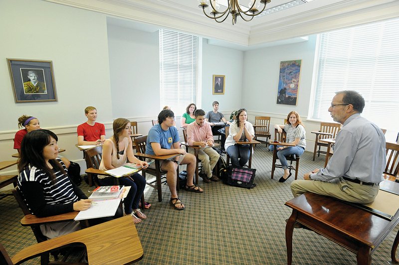 Terrell Tebbetts, right, Lyon College Martha Heasley Cox Chair in American Literature, speaks to a journalism class at Lyon. The school recently announced that it would freeze tuition for the 2013-14 school year. 