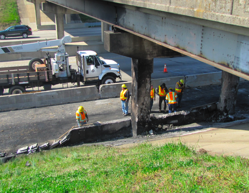 Highway department crews work to brace the Young Road overpass at Interstate 40 late Friday morning.
