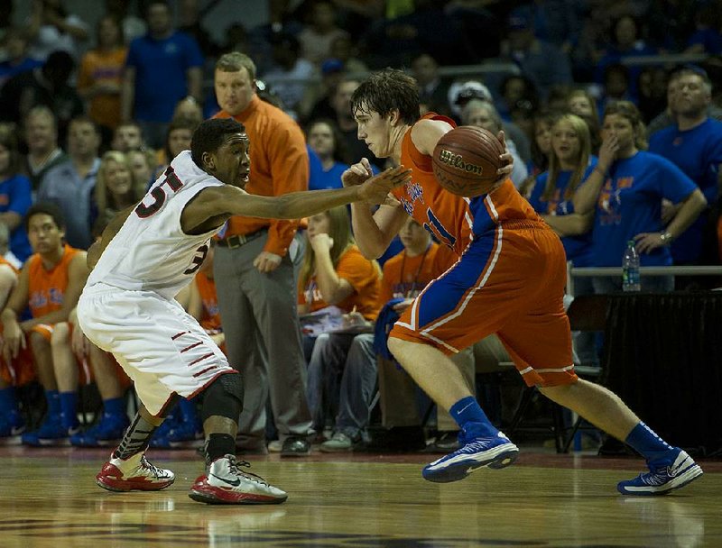 Cedar Ridge’s Spencer Reaves (right) tries to dribble past Malik Monk of East Poinsett County during Saturday’s Class 2A boys state championship game at Barton Coliseum in Little Rock. Reaves had 35 points and seven rebounds to lead the Timberwolves to a 58-56 victory. Monk finished with 25 points. 