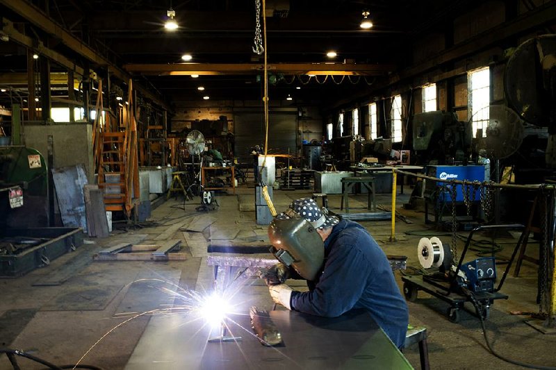A welder builds parts for petroleum tanks at Southern Tank and Manufacturing Inc. in Owensboro, Ky. The U.S. oil and natural gas industry is struggling to find enough skilled workers, an industry report says. 