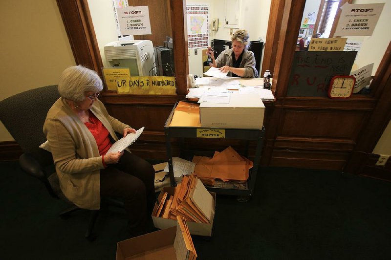 At the state Capitol Monday, Arkansas House of Representatives employees Jimmie White (left) and Laura Butler were busy processing new pieces of legislation. Monday was the deadline for fi ling bills. 