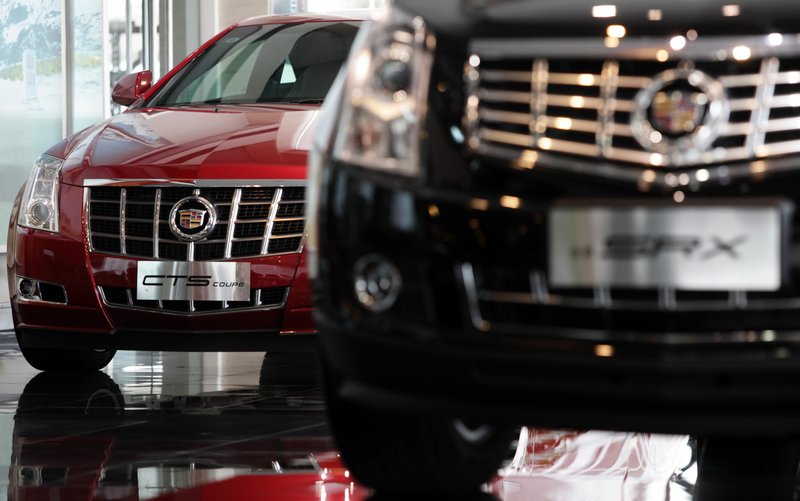 General Motors Co. Cadillac CTS (left) and SRX vehicles are displayed at a dealership in Shanghai in February. Auto sales in China rose in the first two months of 2013, the government said Monday. 