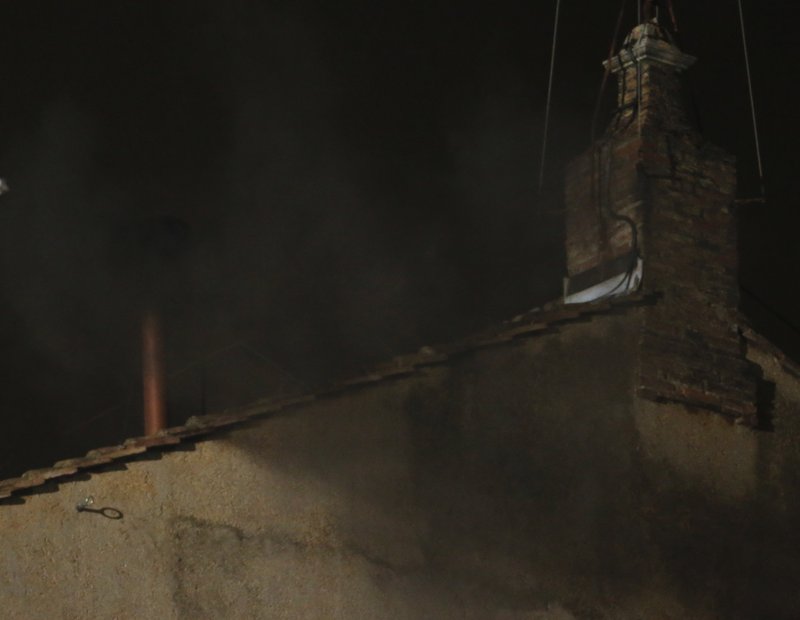 Black smoke emerges from the chimney on the roof of the Sistine Chapel, in St. Peter s Square at the Vatican, Tuesday, March 12, 2013. The black smoke indicates that the new pope has not been elec...