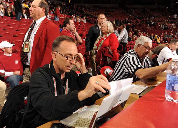 Longtime Arkansas public address announcer John George of Springdale reads pregame announcements Saturday, Feb. 16, 2013, before the start of the Hogs' game with Missouri in Bud Walton Arena in Fayetteville. George will be working the SEC Tournament for the sixth consecutive year. 