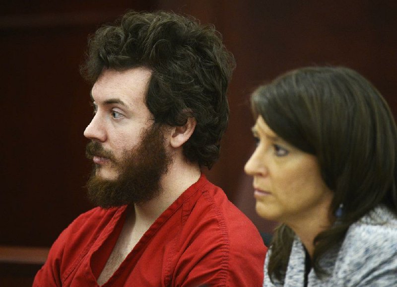 James Holmes sits with defense attorney Tamara Brady during his arraignment in district court in Centennial, Colo., on Tuesday, March 12, 2013. Judge William Blair Sylvester entered a not guilty plea on behalf of James Holmes on Tuesday after the former graduate student's defense team said he was not ready to enter one. (AP Photo/Denver Post, RJ Sangosti, Pool)