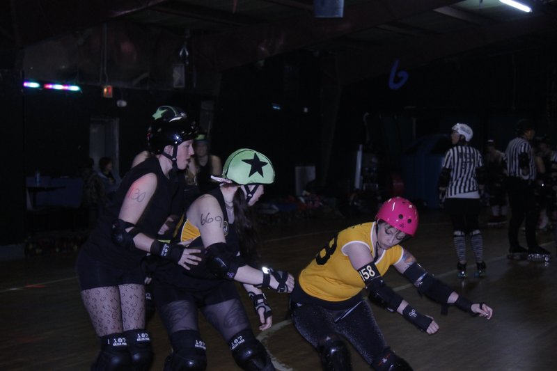 A member of the Girls Rollin’ in the South Roller Derby league blocks a fellow skater during the league’s first public scrimmage of the season on Feb. 26 at the Conway Roller Rink. 