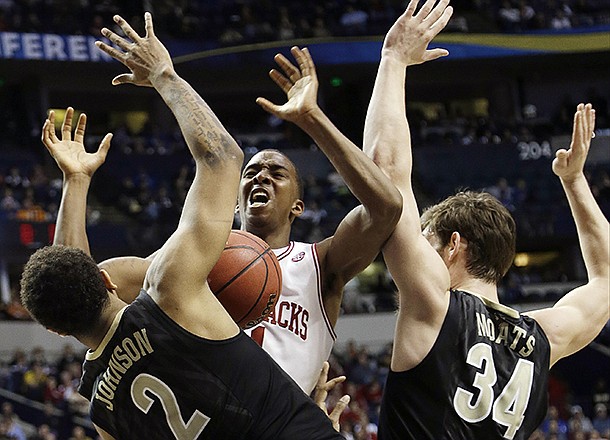 Arkansas guard BJ Young (11) works against Vanderbilt' Shelby Moats (34) and Kedren Johnson (2) during the second half of an NCAA college basketball game at the Southeastern Conference tournament, Thursday, March 14, 2013, in Nashville, Tenn. (AP Photo/Dave Martin)