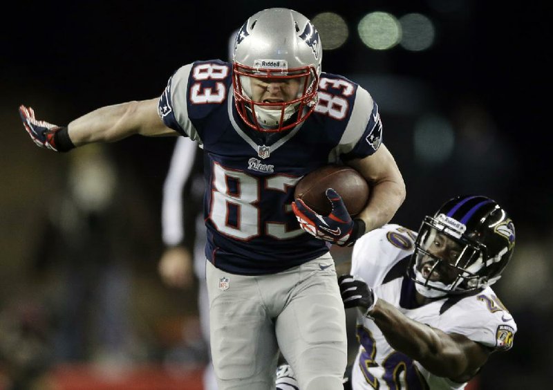 FILE - In this Jan. 20, 2013, file photo, New England Patriots wide receiver Wes Welker (83) runs out of the tackle of Baltimore Ravens free safety Ed Reed (20) during the first half of the AFC championship NFL football game in Foxborough, Mass.  All 32 teams are under the $123 million salary cap, but how much teams want to wheel and deal is unclear. Those available include Ed Reed and Dashon Goldson and Welker. (AP Photo/Matt Slocum, File)