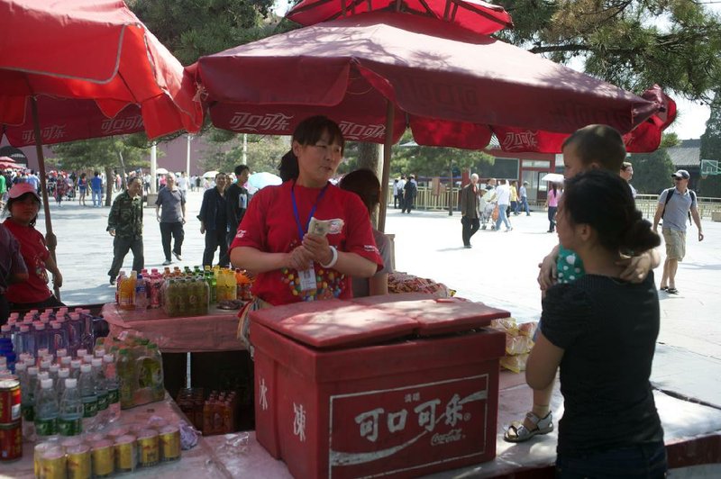 A vendor sells Coca-Cola Co. products in Beijing, China, on Thursday, June 2, 2011. Coca-Cola Co., the world's largest soft-drink maker, is in talks with China's government to list shares in Shanghai as the company accelerates expansion in the world's most populous nation. Photographer: Keith Bedford/Bloomberg