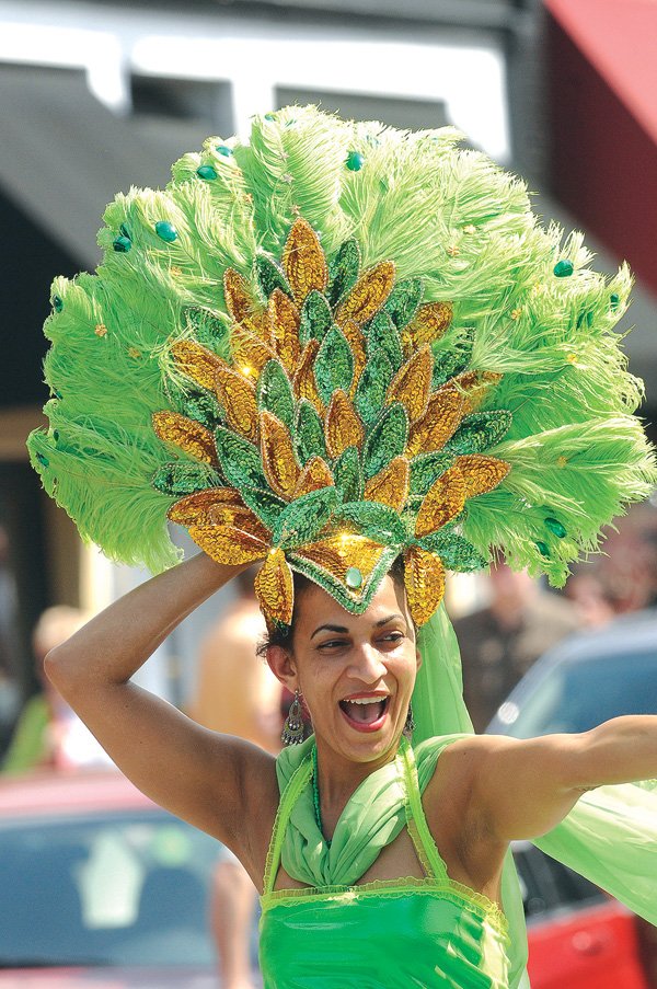 Fatima Pollard from Brazil chose her St. Patrick’s Day costume from an assortment of Mardi Gras dresses before marching in the first ever St. Patrick’s Day Parade in downtown Fayetteville last year.