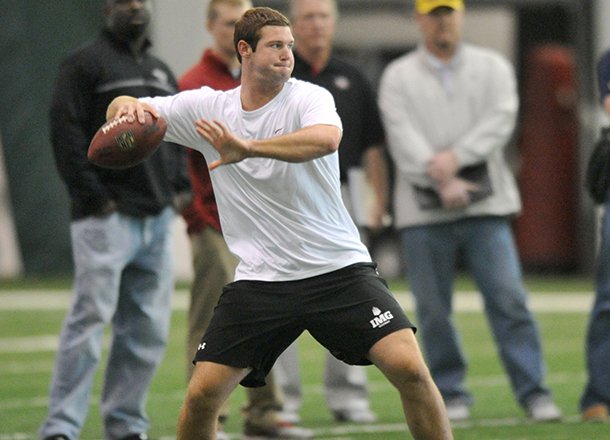 Quarterback Tyler Wilson runs drills for NFL scouts Friday afternoon at Walker Pavilion during Pro Day at the University of Arkansas in Fayetteville.